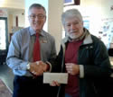 Brian Joyce presents the cyclists' donation to Tudor Rose manager, Andrew Town.